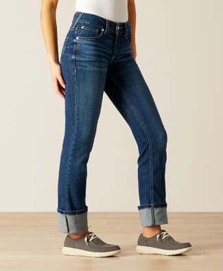 woman standing in straight leg jeans